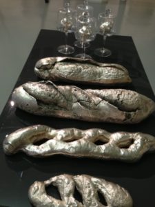 installation view of cast Bronze and Silver Platted Breads on stainless Steel table (1 0f 5 tables)